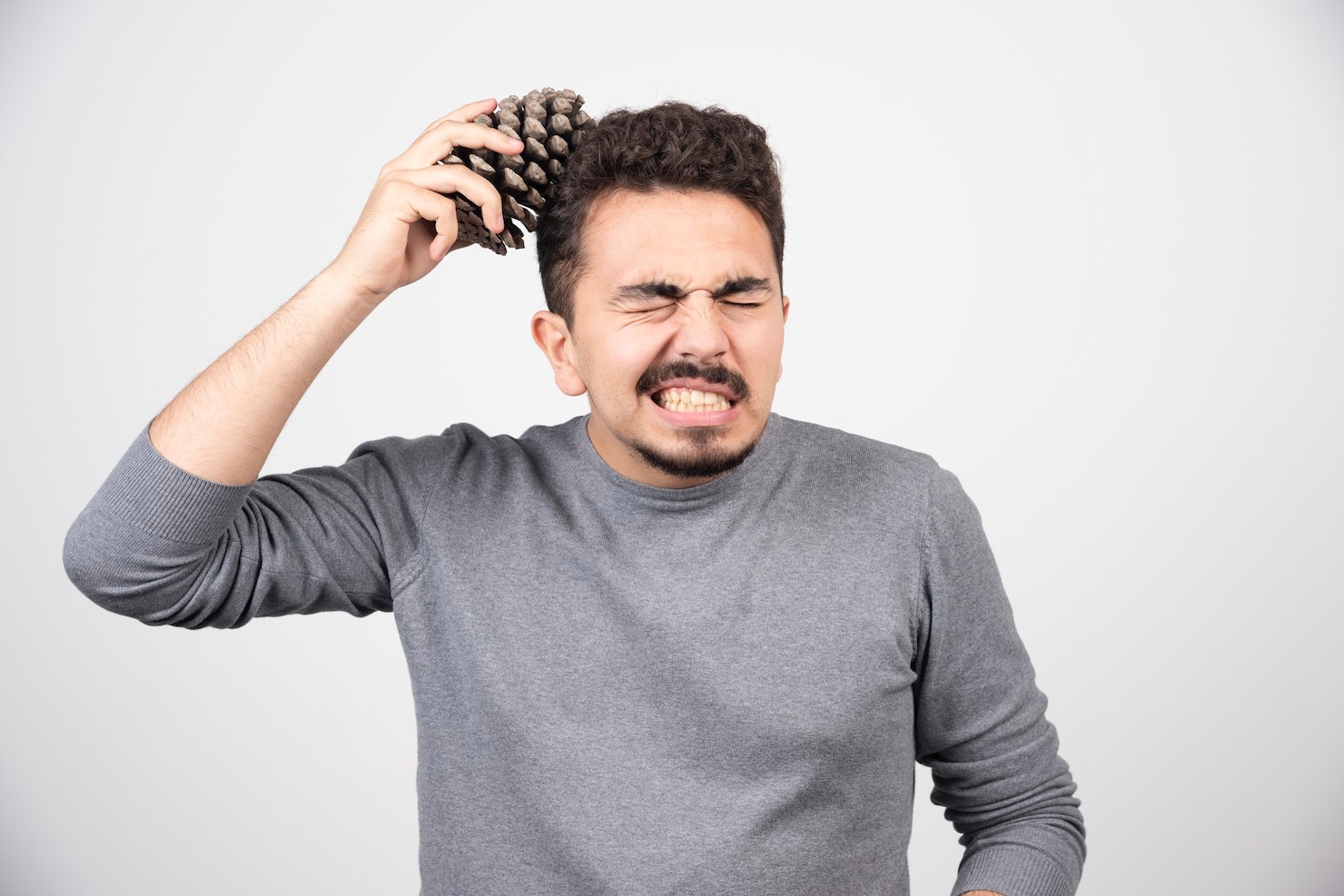 young-man-putting-pinecone-overhead 114579-42117