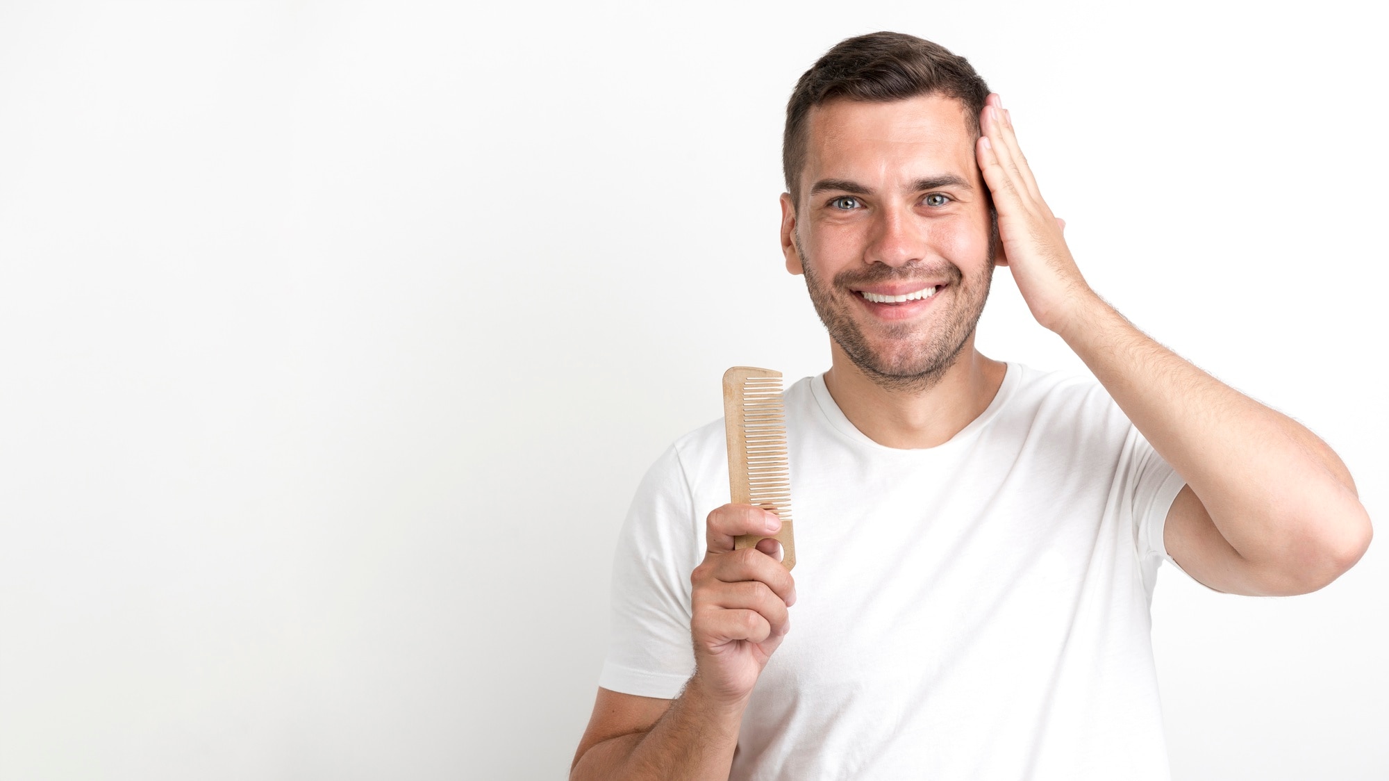 young-man-holding-comb-set-his-hair-against-white-background 23-2148213326