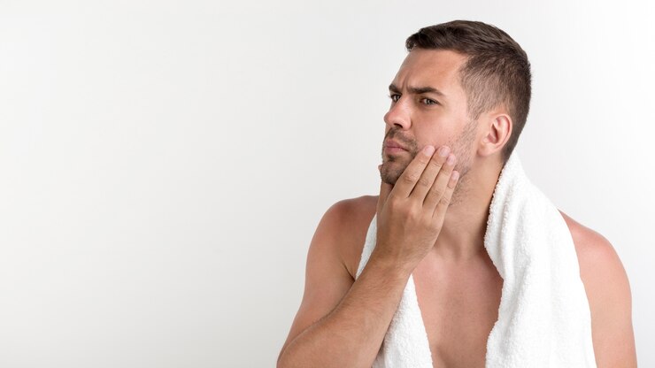 shirtless-man-with-towel-around-his-neck-checking-face-standing-against-white-background 23-2148213357 (1)