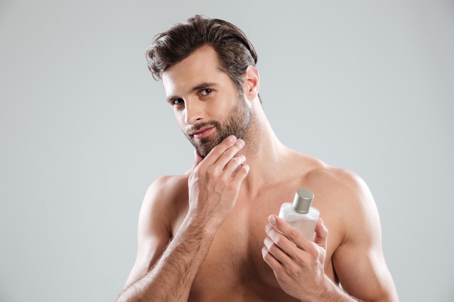 man-touching-his-face-while-holding-bottle-perfume 171337-17361