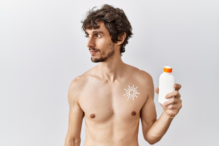 young-hispanic-man-standing-shirtless-holding-sunscreen-lotion-looking-side-relax-profile-pose-with-natural-face-confident-smile 839833-10407 (1)