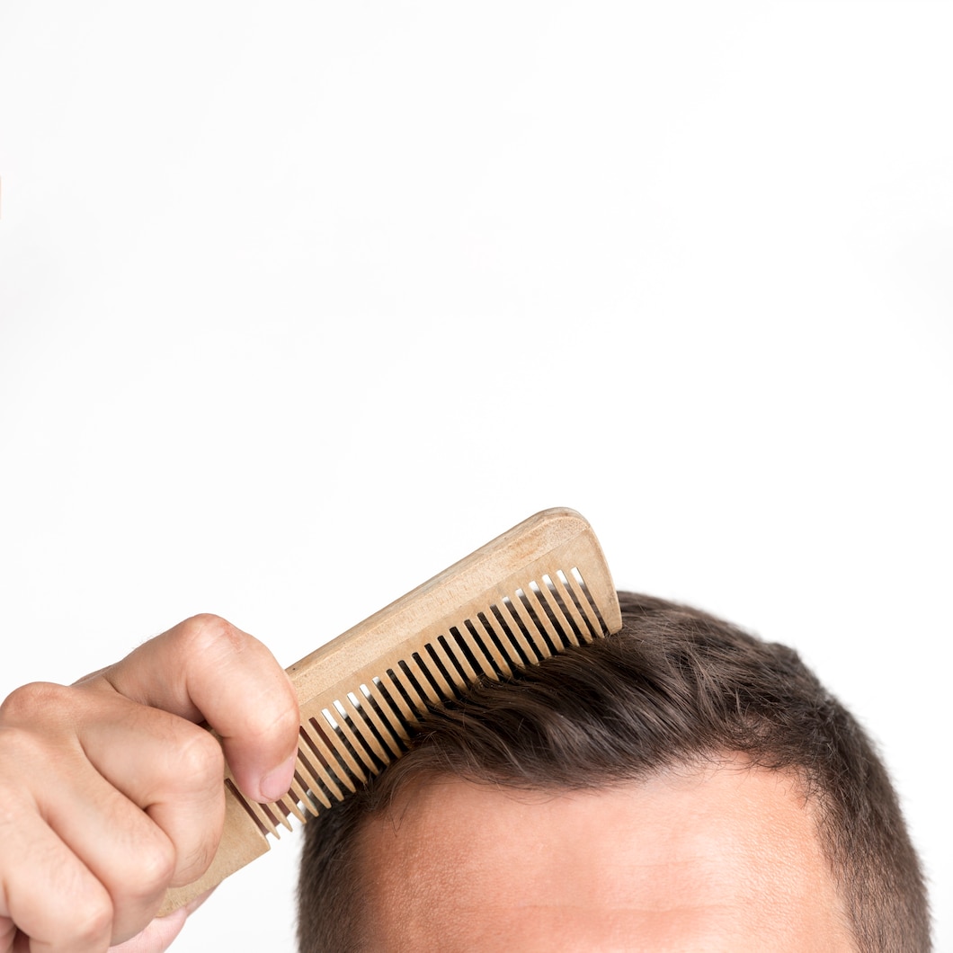 close-up-young-man-comb-his-hair-against-white-background 23-2148213323