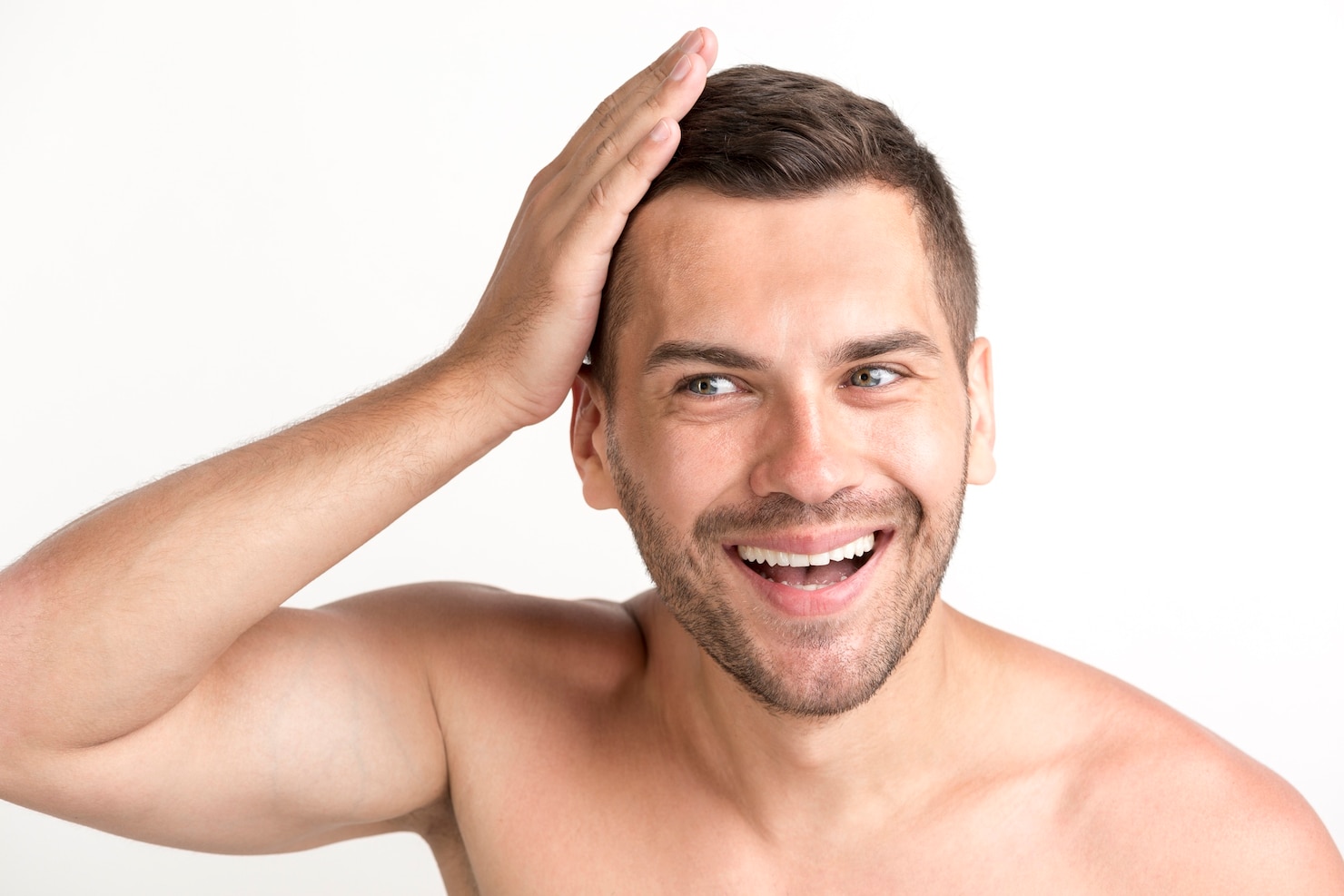 smiling-young-shirtless-man-touching-his-hair-white-backdrop 23-2148213289