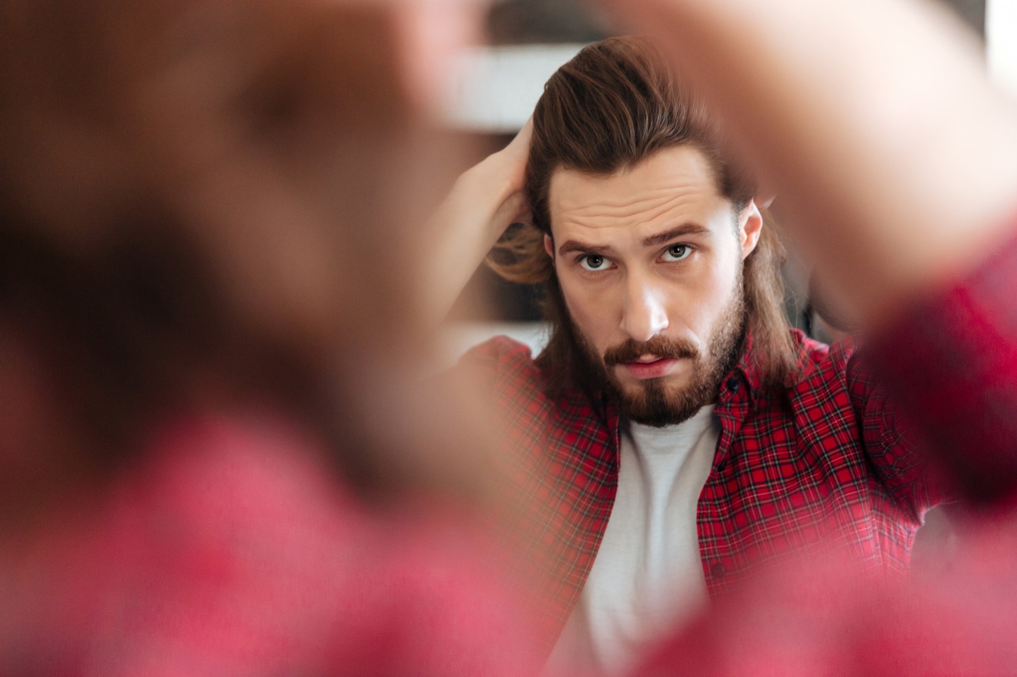 man-plaid-shirt-standing-looking-mirror 171337-19878