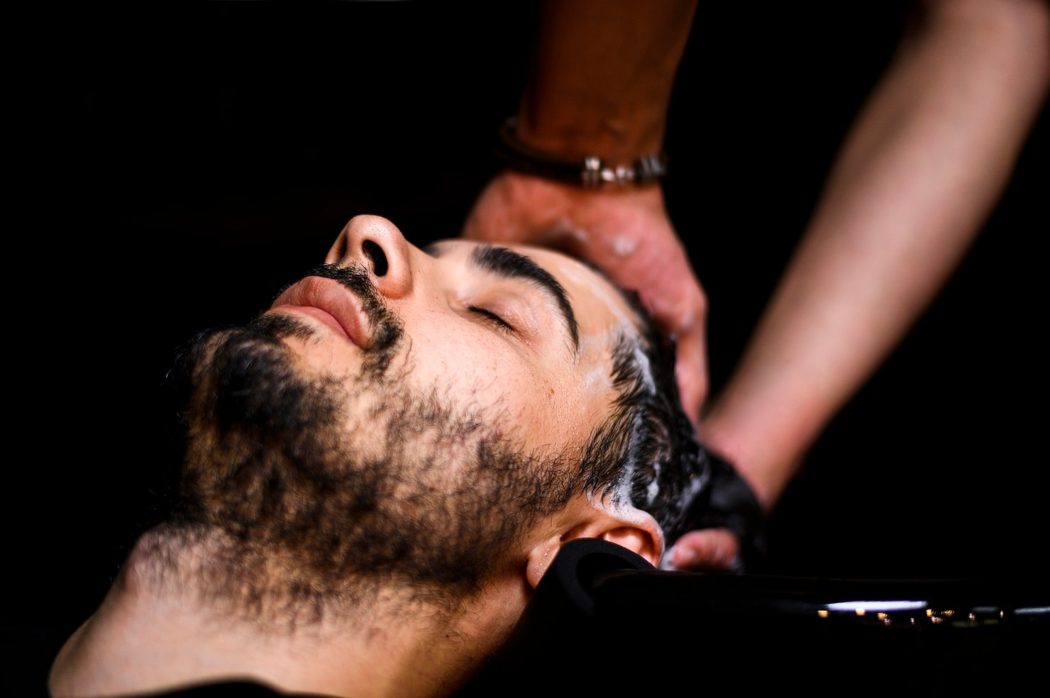 man-having-his-hair-washed-salon 23-2148242829