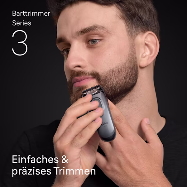 Junger Mann stutzt den Bart an seinem Kinn mit dem Braun Barttrimmer Series 3