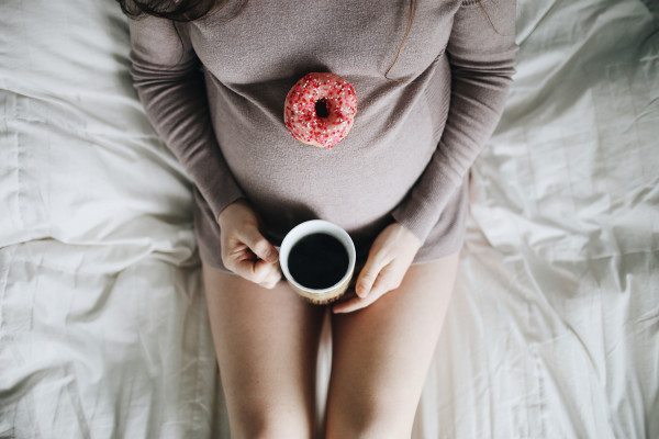pregnant-woman-with-mug-of-tea-and-doughnut-RS