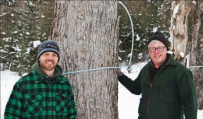John Buck (right) with his son, James (left), work closely together on the family’s maple syrup operation.
