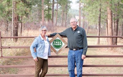 Mary and Bob in front of their ATFS sign on their property in South Dakota.