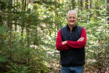 Tim Stout, an FFCP enrolled landowner from Vermont, stands in the woods he proudly stewards.