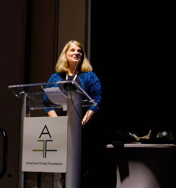 Jan Bernu standing on stage accepting her National Inspector of the Year Award.