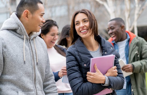 A group of students chatting and laughing