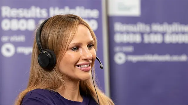 Smiling woman wearing headset while on the phone