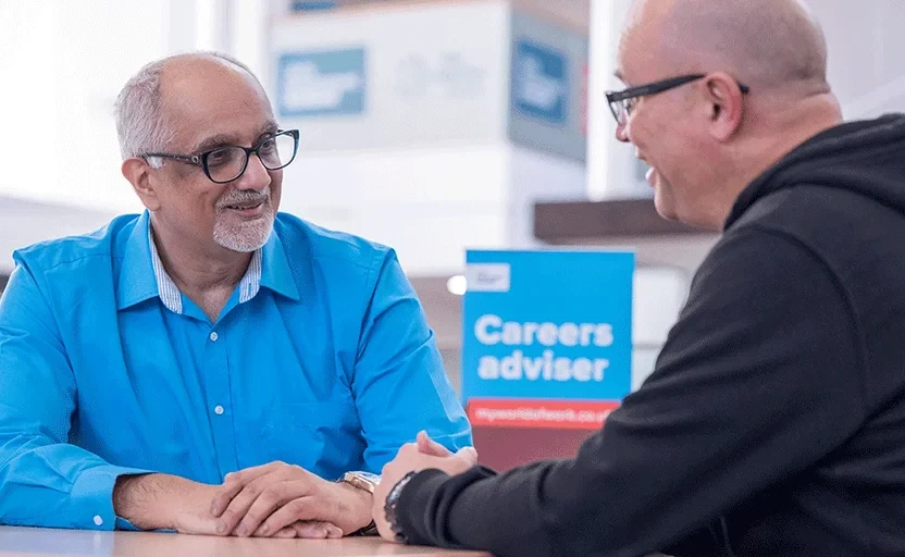 Two men talking in a career centre.