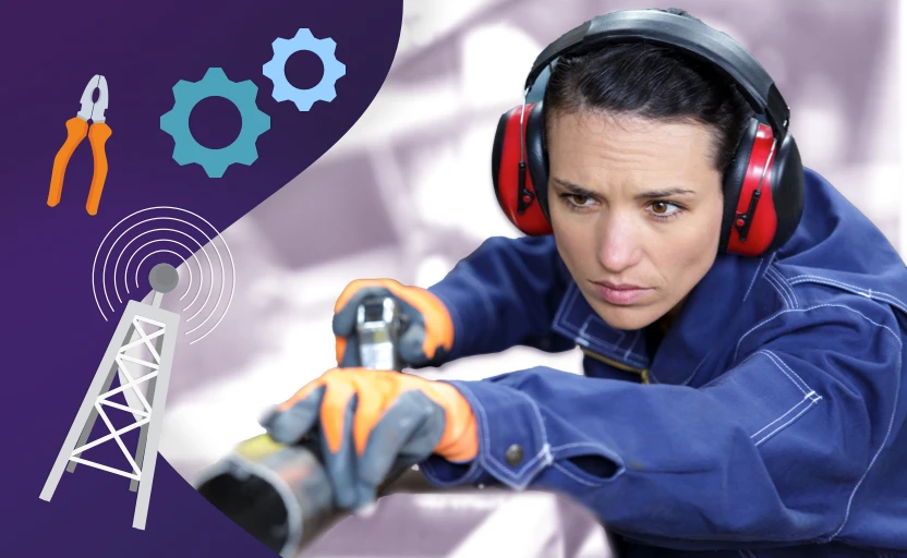 Female engineer with ear defenders working with tools