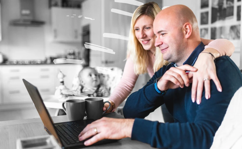 man and woman smiling looking at laptop