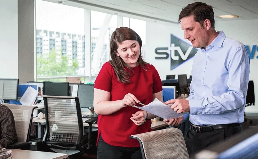 man and woman looking at a document