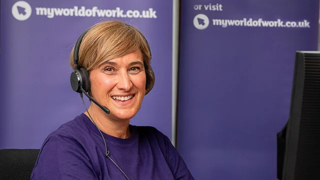 Smiling careers adviser answering phone call