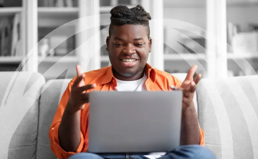 Man smiling at laptop