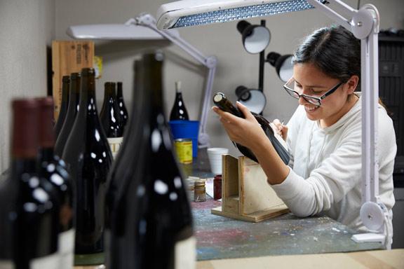 Hand painting wine bottles