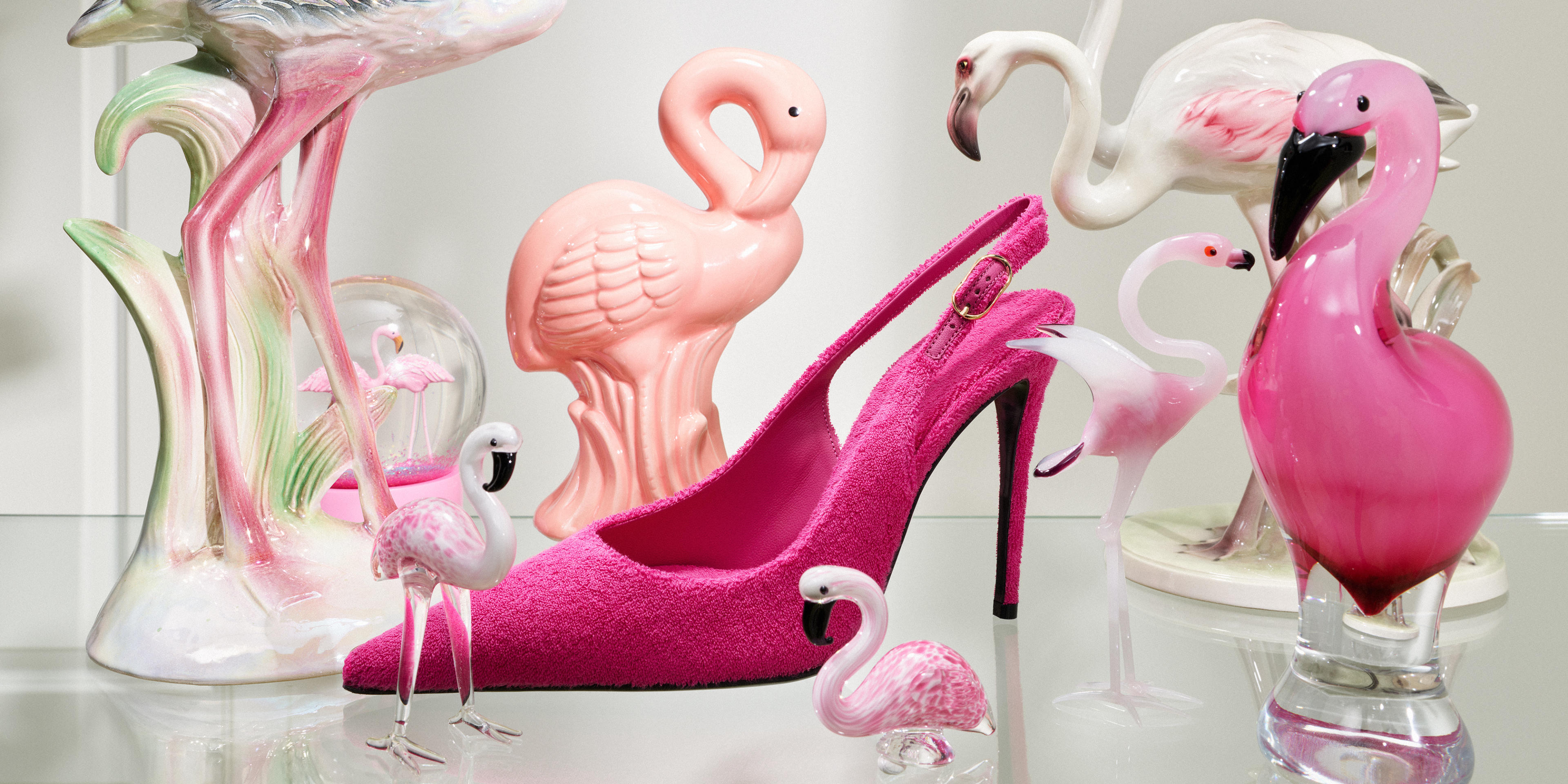 High heel surrounded by flamingoes
