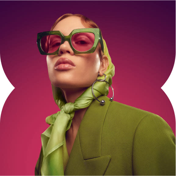 Woman with green clothes and sunglasses