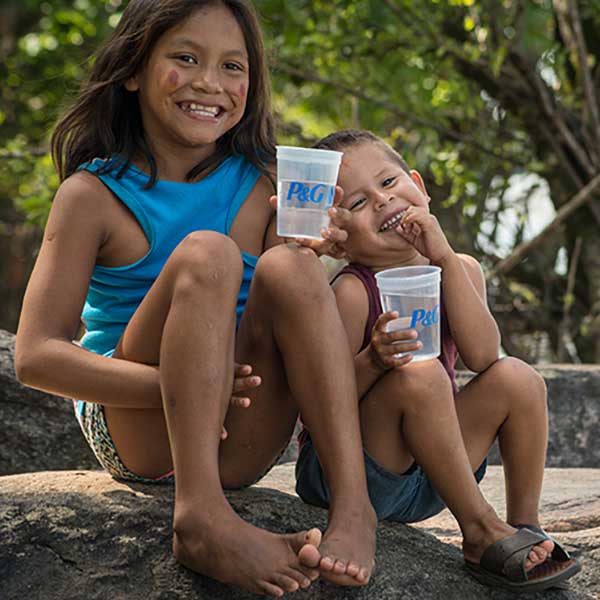 Children smiling with the glass of water