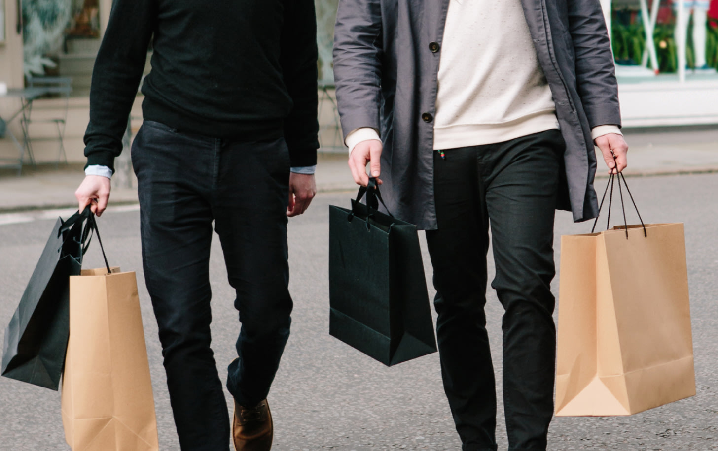 two people with shopping bags