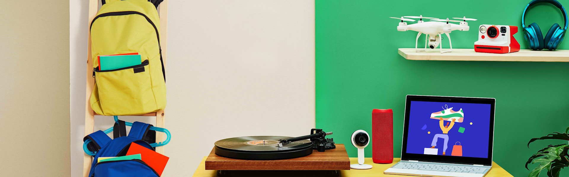Room with backpacks, record player, webcam, laptop