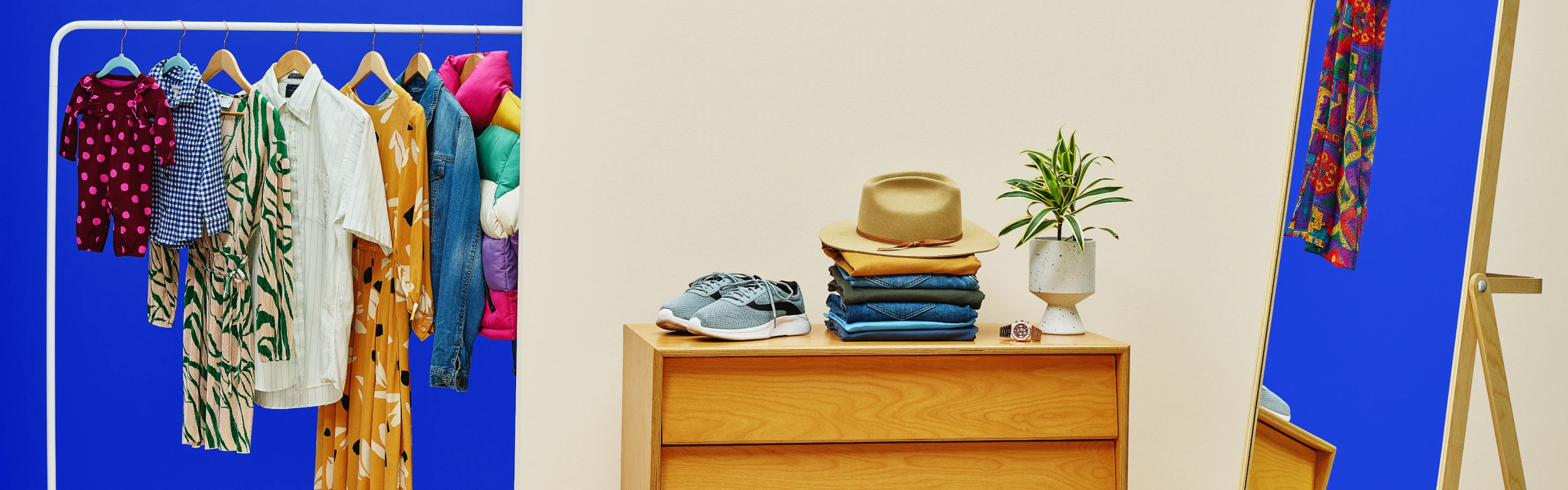 image of clothes on rack and folded stacked clothes on table