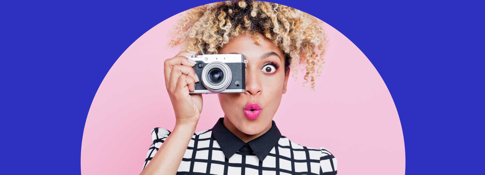 Stylized photo of a female traveler using a camera in a playful way to also post for a shot