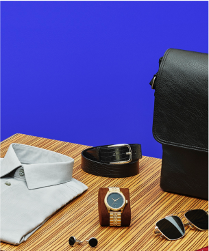 image of dress shirt, watch, cufflinks, belt and sunglasses next to leather briefcase