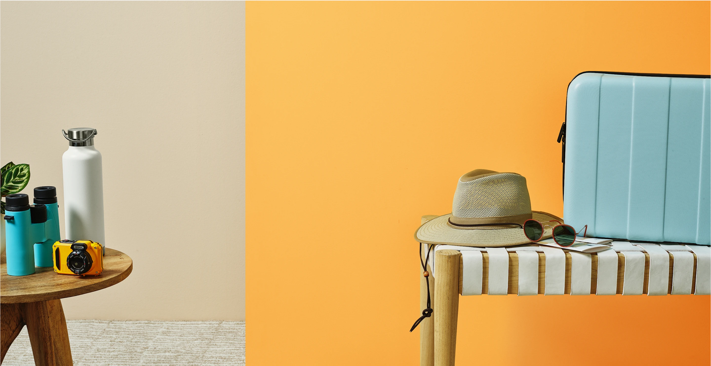 Hat, sunglasses and camera on small table