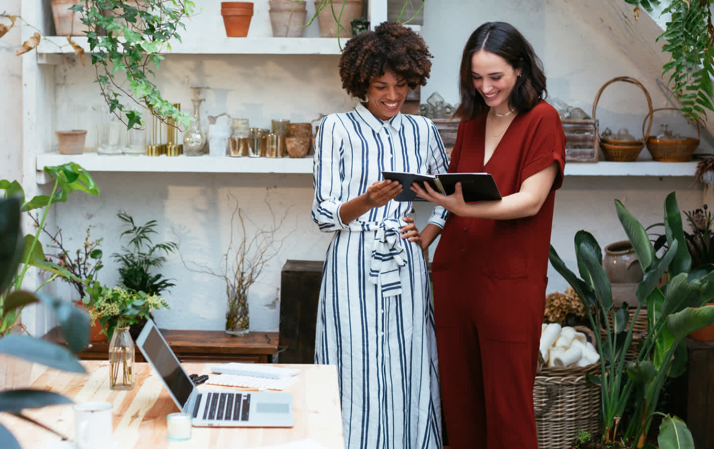 two women looking at ipads