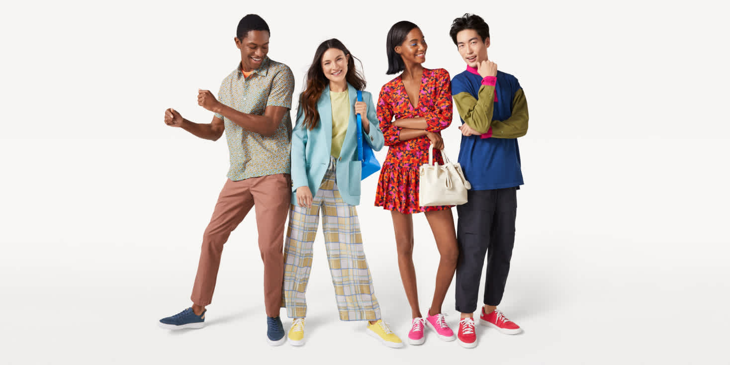 4 models in playful pose wearing Cole Haan shoes