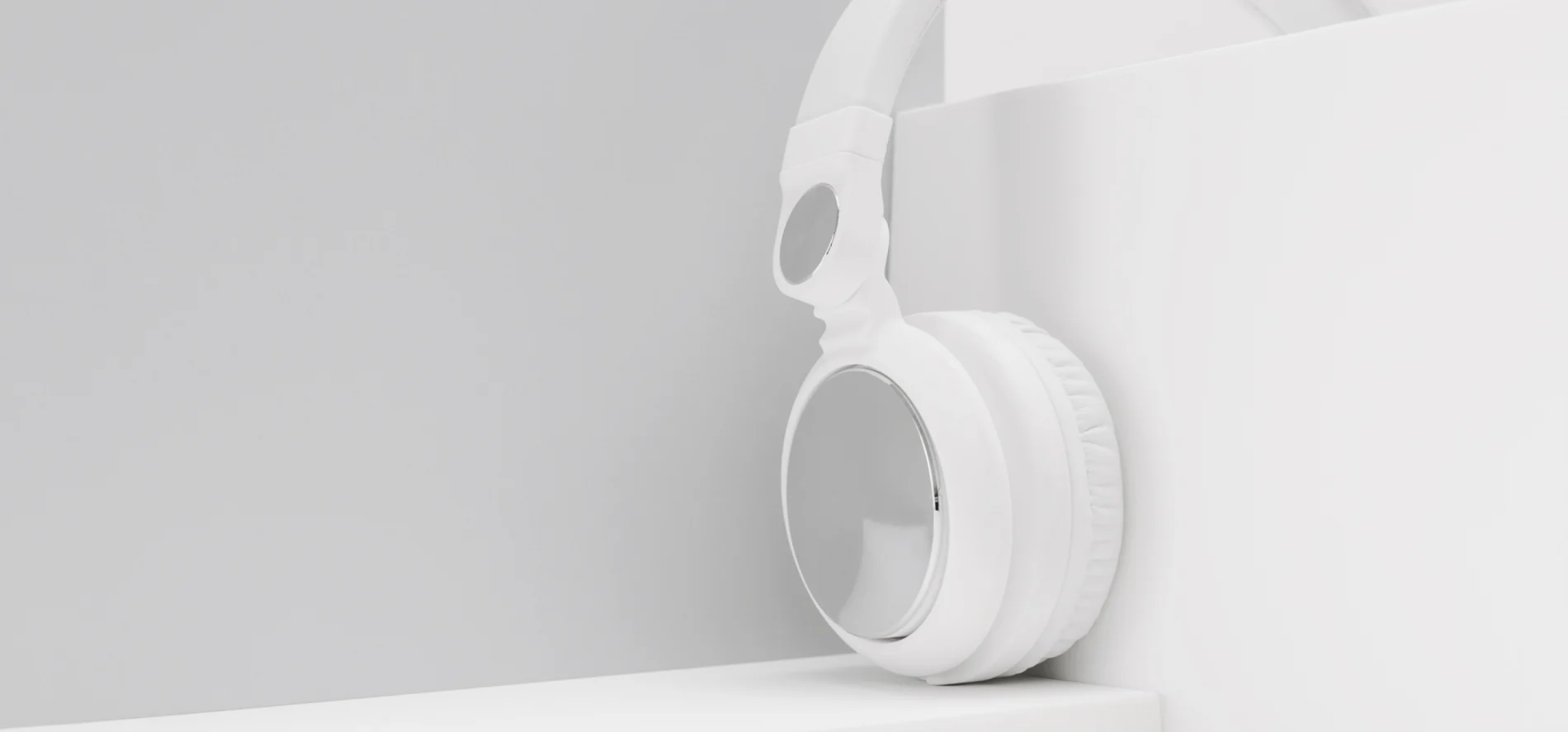 Image of a white headphone balancing on a white divider