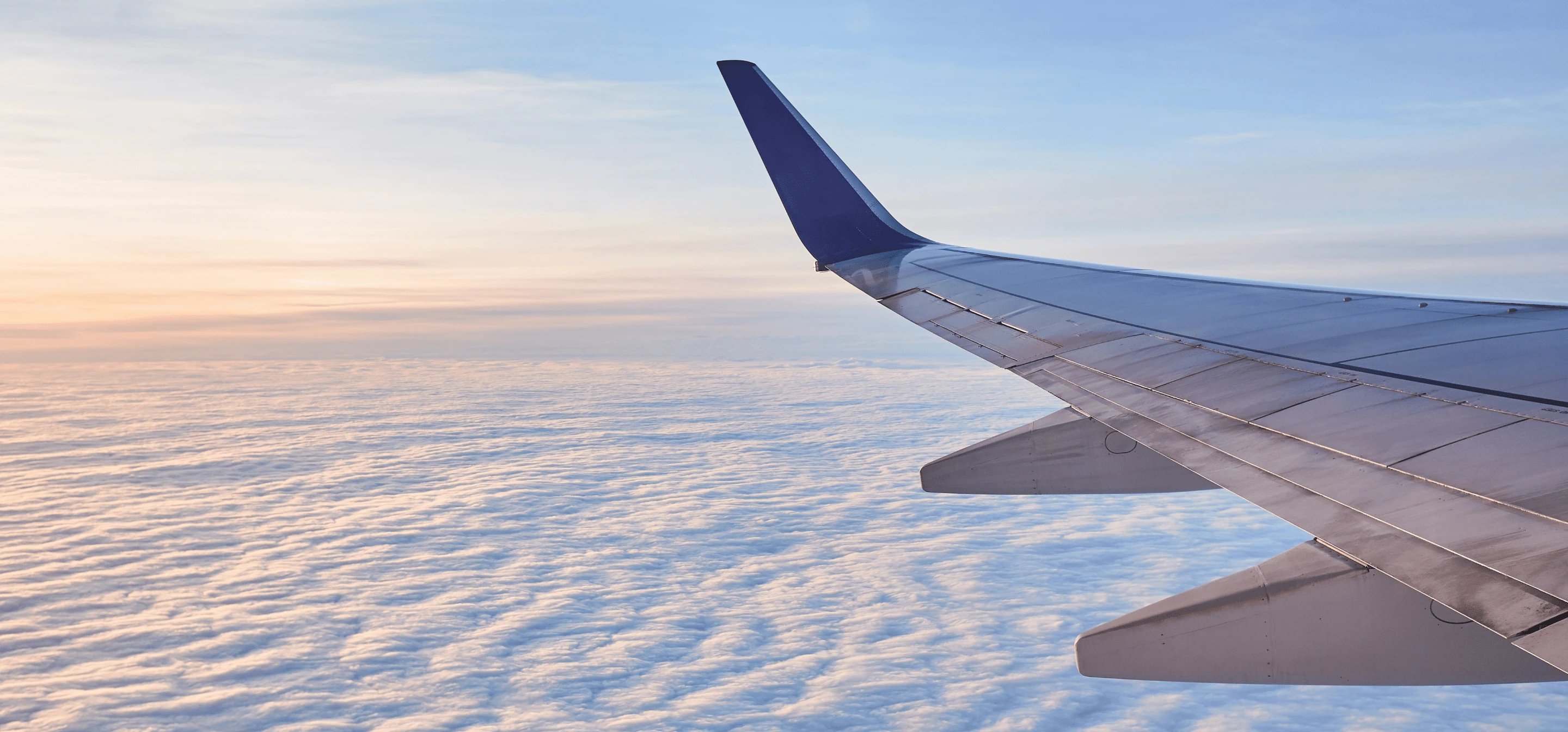 Image of airplane flying over a sea of clouds