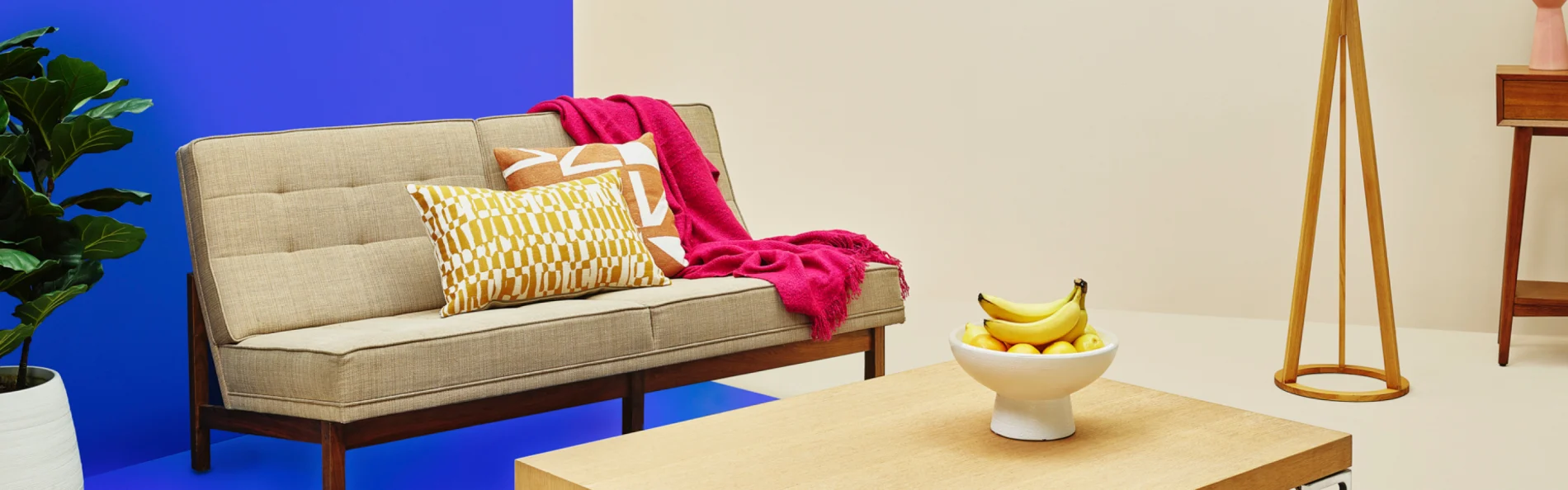 image of a couch with fruit in a bowl on coffee table