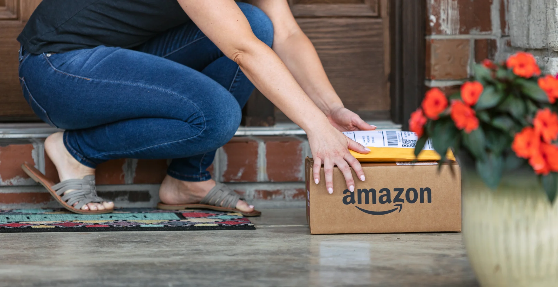 person getting Amazon delivery from porch