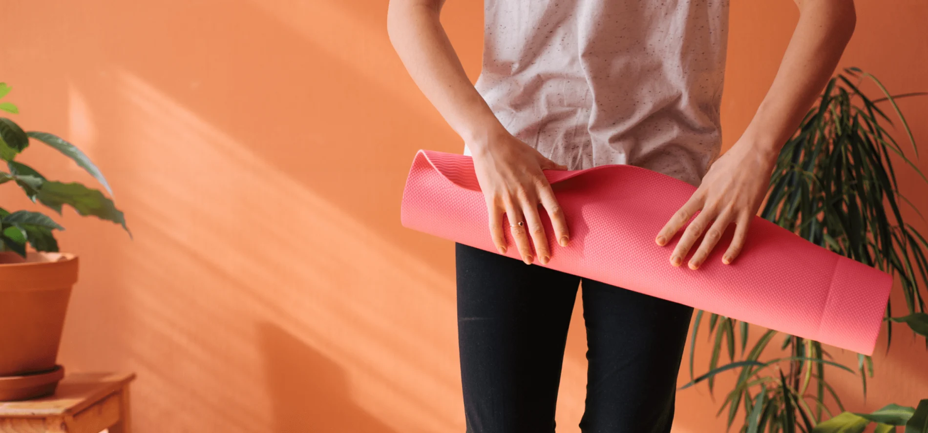 Person holding a yoga mat