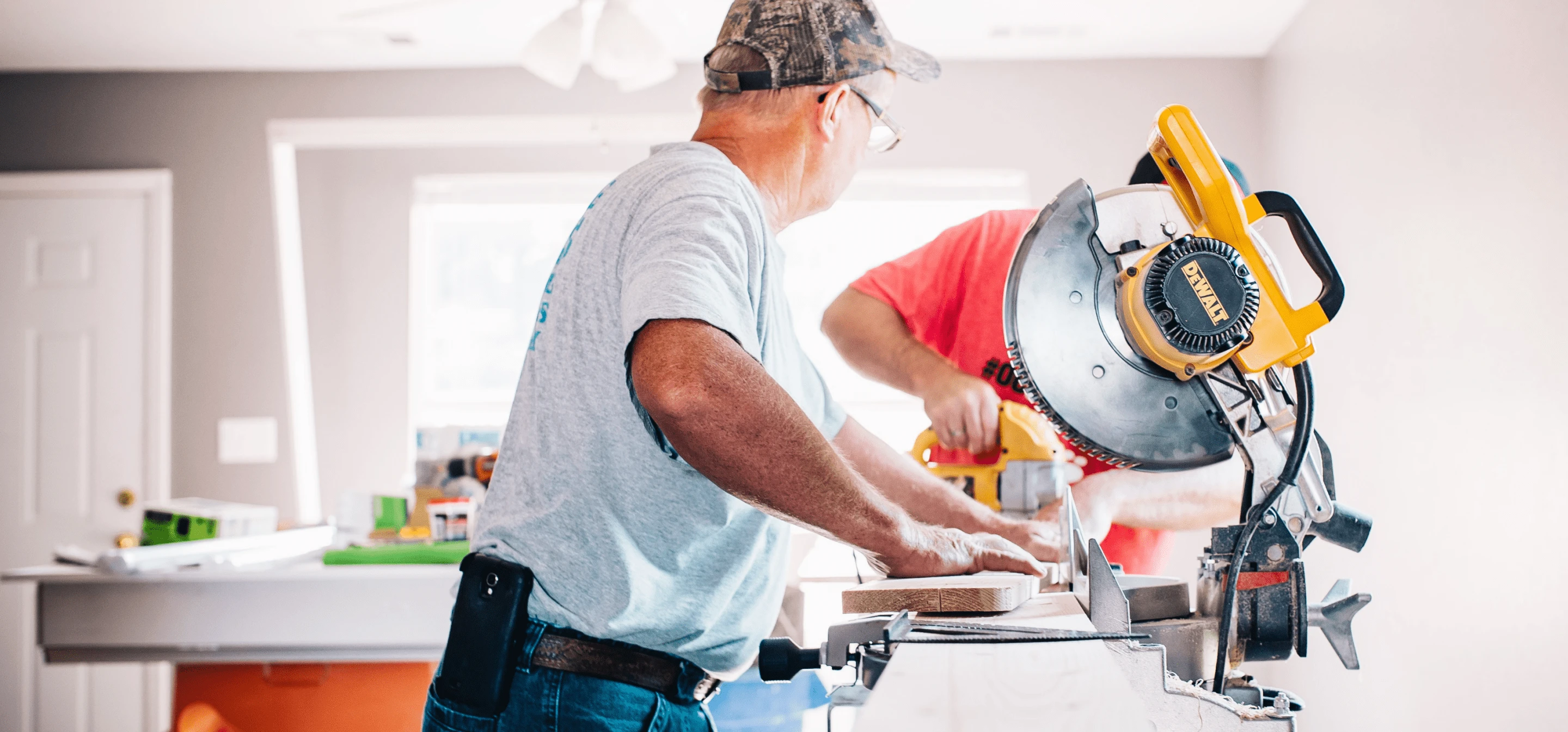 Image of two people using a table saw