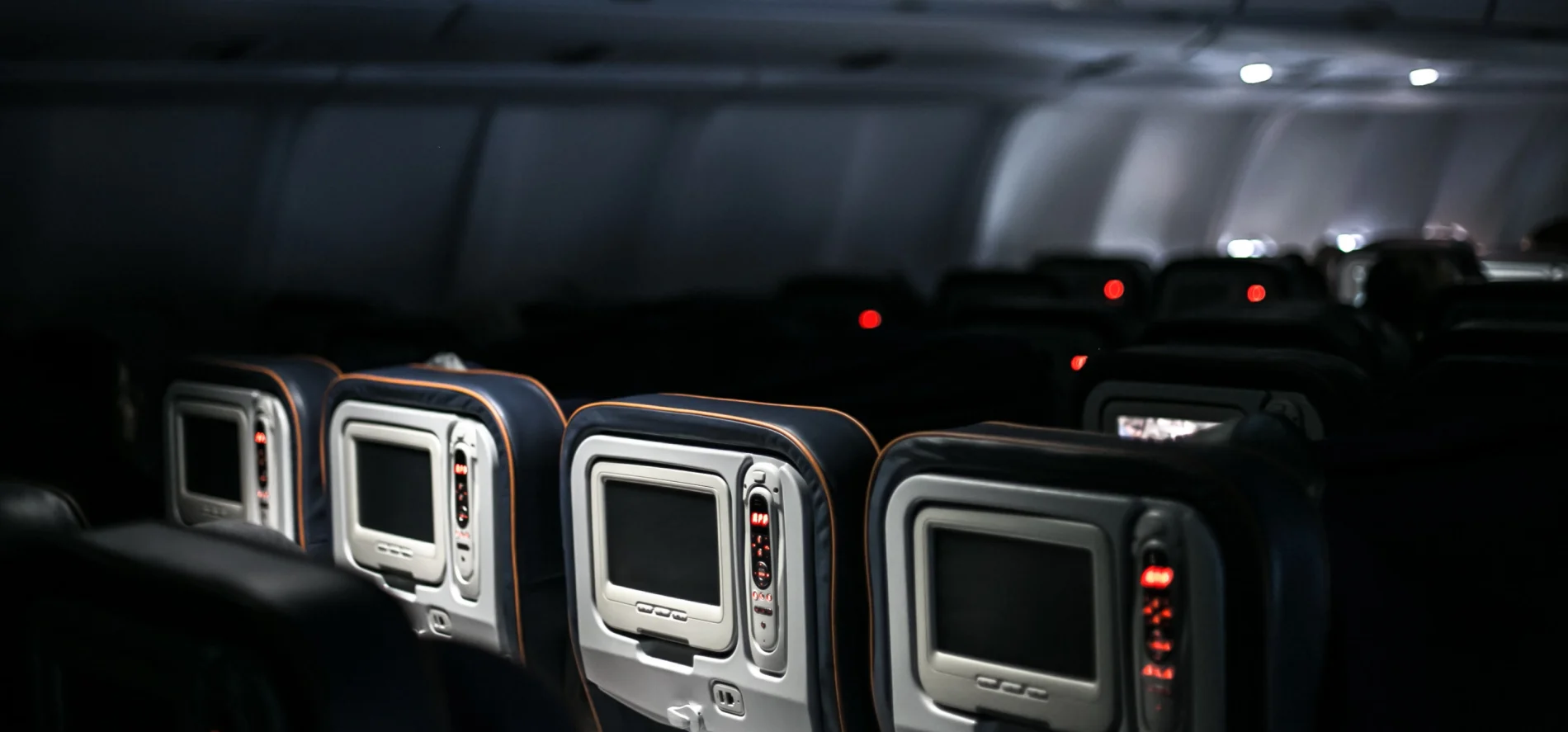 Image of the inside of an airplane entertainment screens and controllers