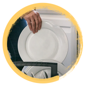 Image of a hand placing a dish into a dishwahser