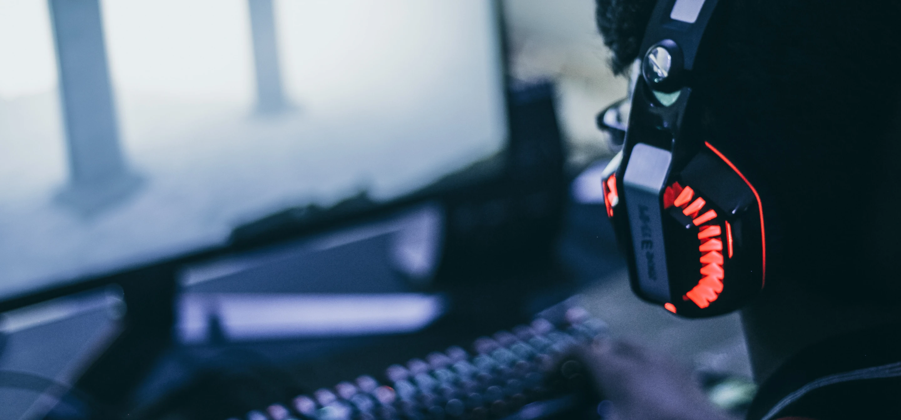 Image of a pair of person wearing headphones staring at screen