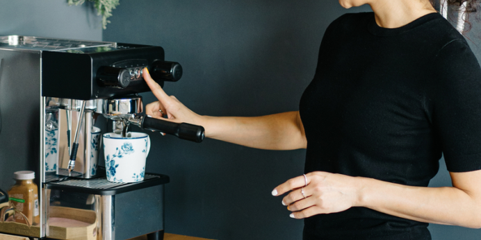 Woman using a new coffee machine