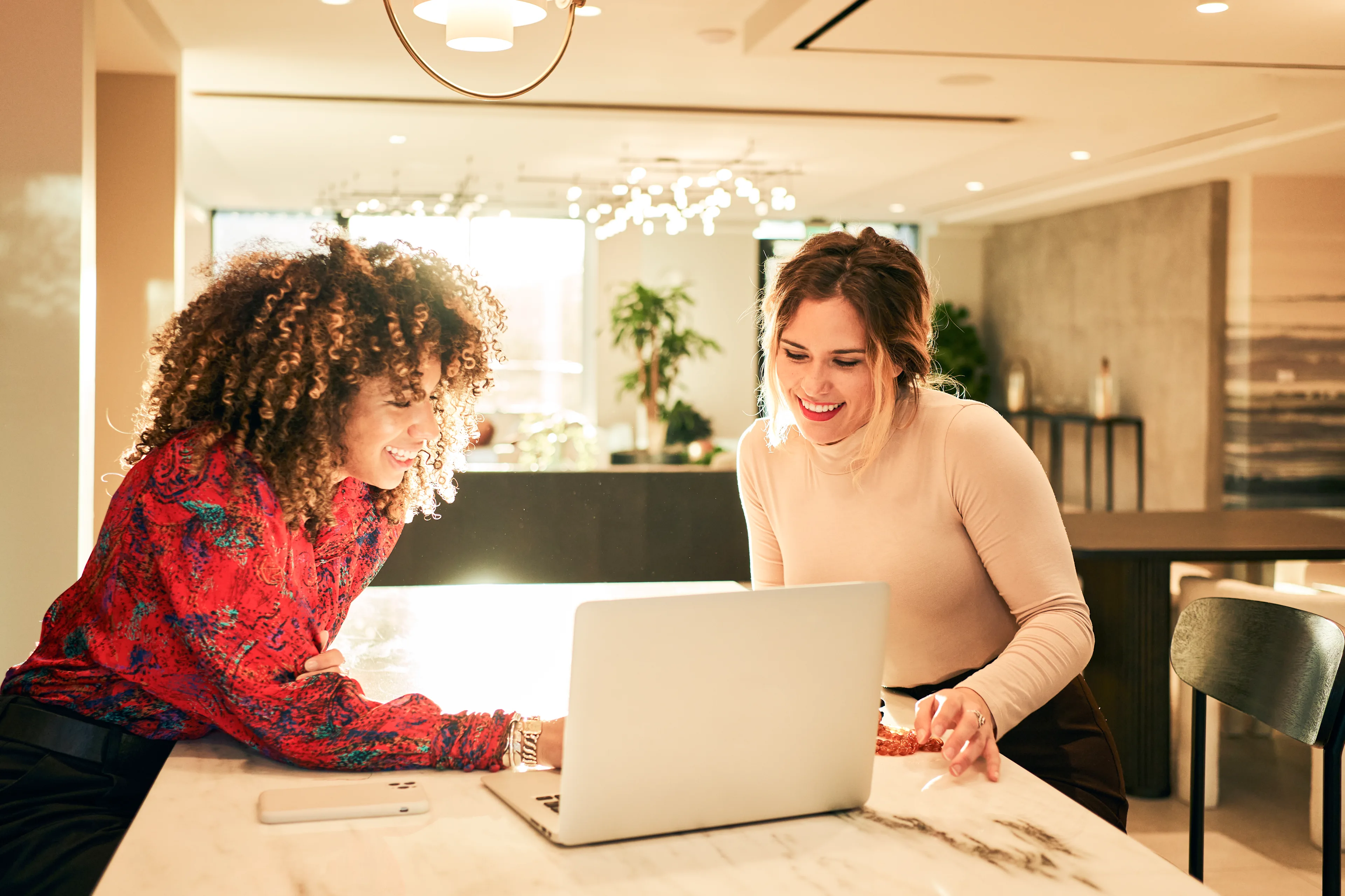 Two women at table with laptop 