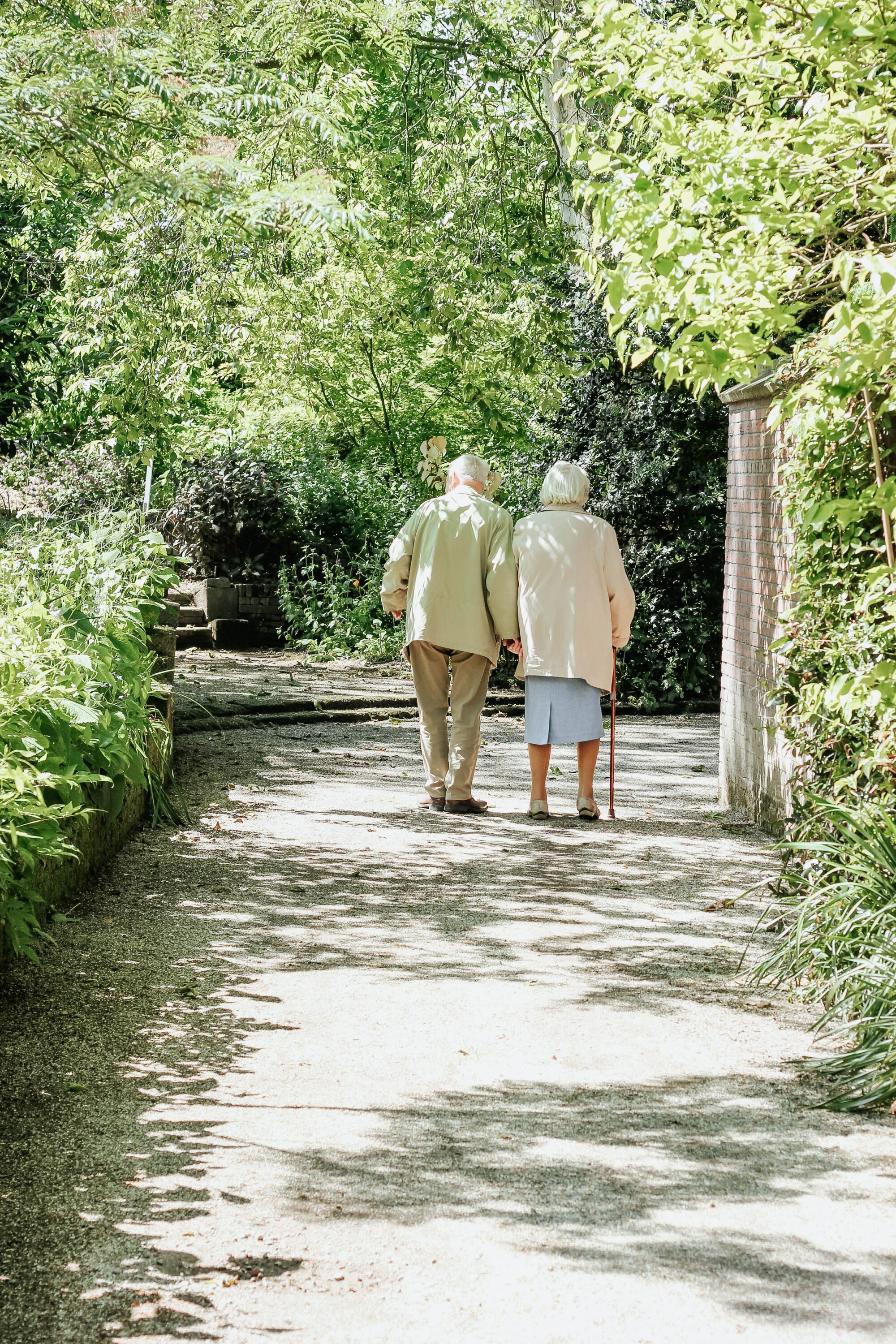 old couple walking in the woods