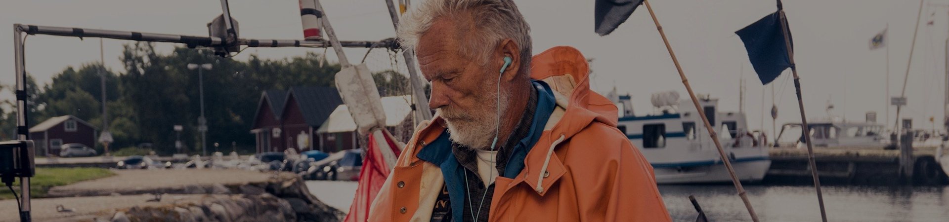 A fisherman listens to an audiobook