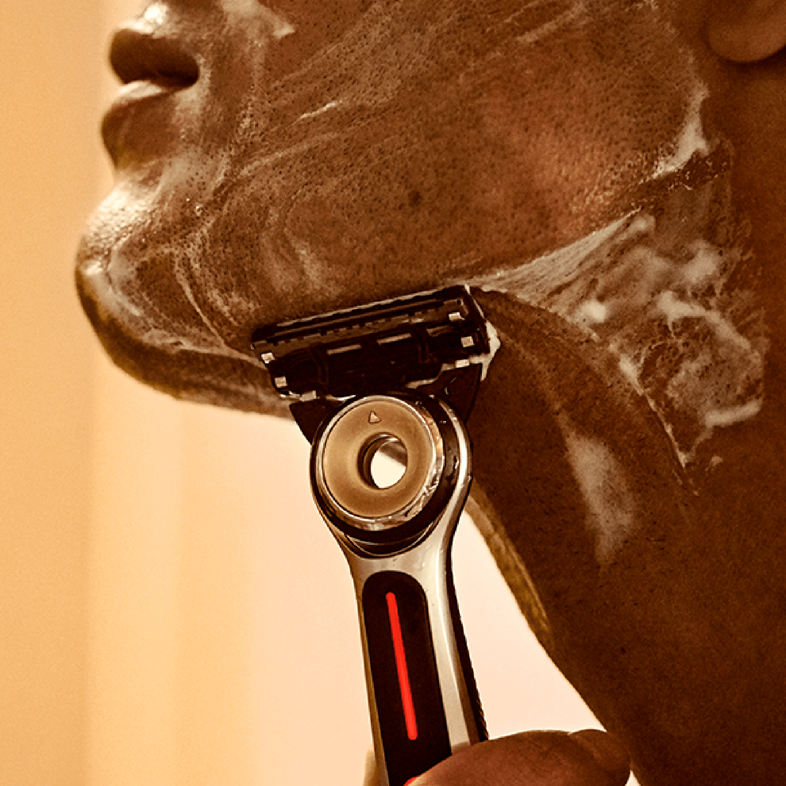 Ein Mann, der sich mit GilletteLabs Heated Razor rasiert