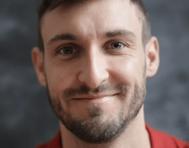 Man with a short beard, smiling, suitable for round face beard style inspiration 